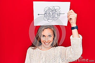 Young beautiful blonde woman holding a picture of chaos and stress looking positive and happy standing and smiling with a Stock Photo