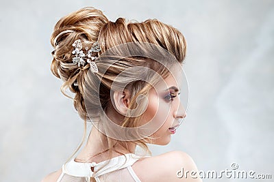 Young beautiful bride with an elegant high hairdo. Wedding hairstyle with the accessory in her hair Stock Photo