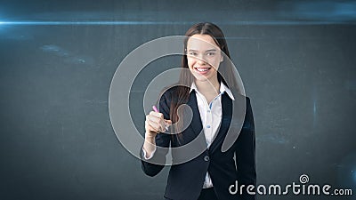 Young beautiful businesswoman with pen writing on the screen. Stock Photo