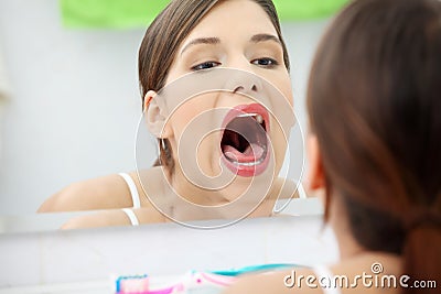 Young beautiful caucasian woman checking throat Stock Photo