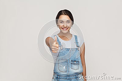 The young beautiful cheerful mixed race woman showing thumb up a Stock Photo
