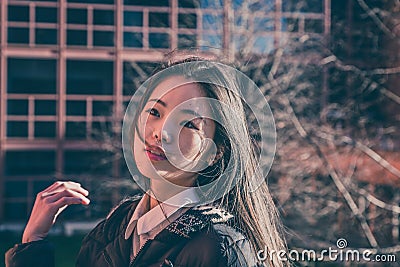 Young beautiful Chinese girl posing in the city streets Stock Photo