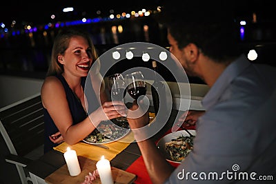 Young beautiful couple having romantic dinner on rooftop Stock Photo