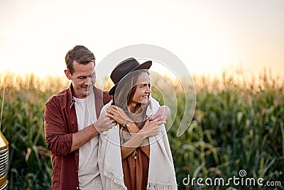 Young beautiful couple take a break during trip, stopped near cornfield, enjoy Stock Photo
