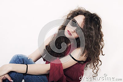 Young beautiful curly brunette woman in sunglasses Stock Photo