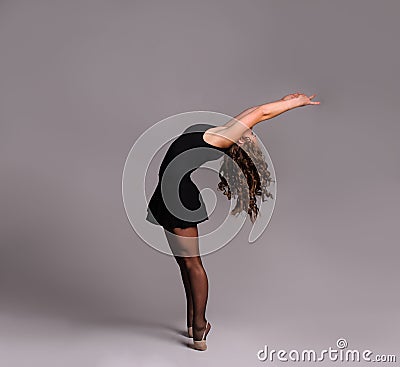 Young beautiful dancer gymnastics posing in studio Stock Photo