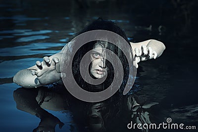 Young beautiful drowned ghost woman in the water Stock Photo