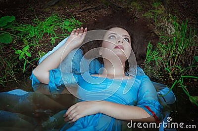 Young beautiful drowned woman lying in the water Stock Photo