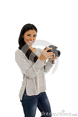 Young beautiful exotic hispanic photographer woman smiling happy looking reflex camera Stock Photo