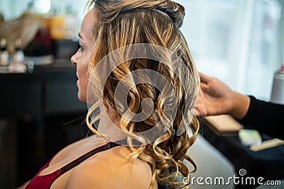 Young Beautiful Female Getting Hair Curled Stock Photo