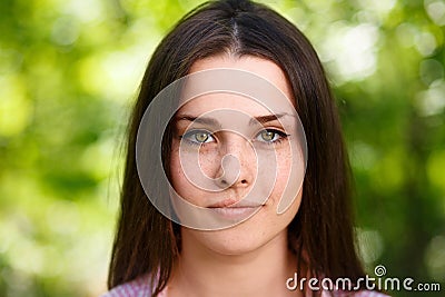 Young beautiful freckled green-eyed woman face portrait with hea Stock Photo