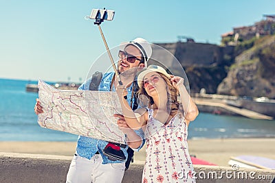 Young beautiful friends tourist couple and taking selfie stick picture together in town happy on sunny day Stock Photo