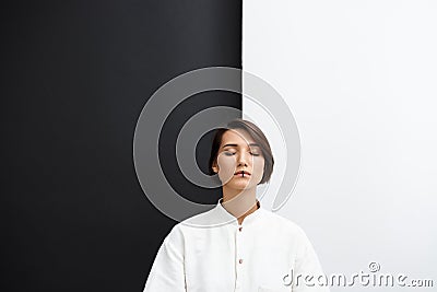 Young beautiful girl with closed eyes over black and white background. Stock Photo