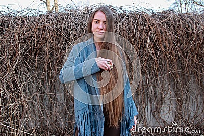 Young beautiful girl combing long brown hair Stock Photo