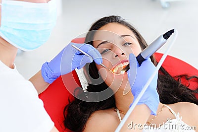 Young beautiful girl in dental office. Children`s dentist examines teeth to a child Stock Photo