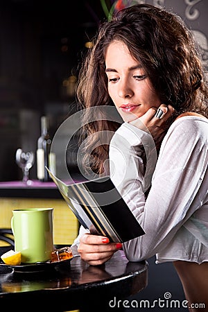 Young beautiful girl enjoying in cafe bar Stock Photo