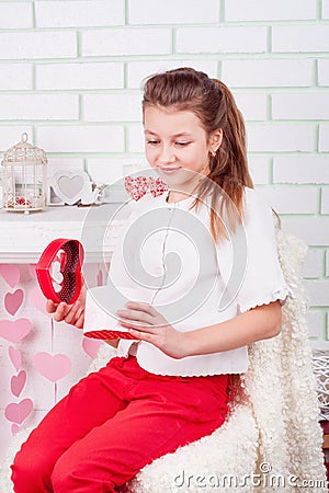 Young beautiful girl opening present box Stock Photo