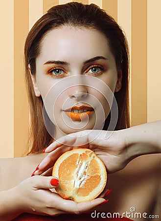 Beautiful girl with an orange Stock Photo