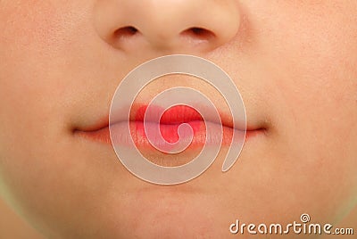 Young beautiful girl playing with heart drawing on lips Stock Photo