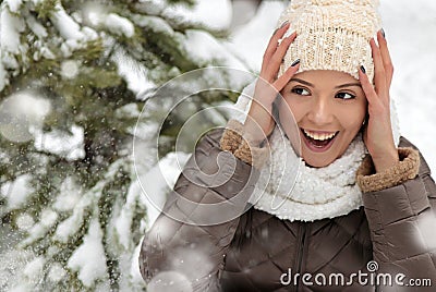 A young beautiful girl rejoices in the winter snow Stock Photo