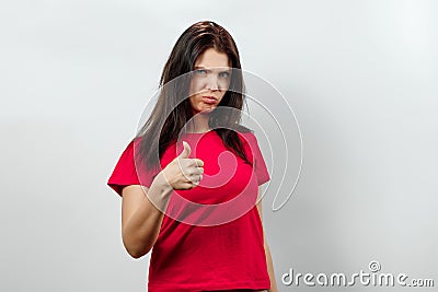 Young, beautiful girl showing a gesture with her hands thumbs up. Isolated on a light background. Different human emotions, Stock Photo