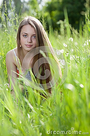 Young beautiful girl siting in the grass Stock Photo
