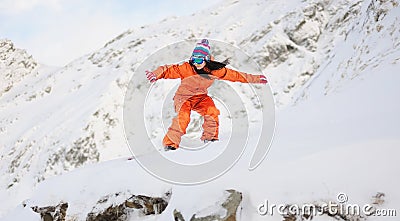 Young beautiful girl snowboarder in motion Stock Photo
