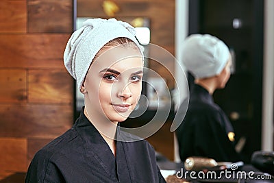 Young, beautiful girl with a towel on his head after shampooing Stock Photo