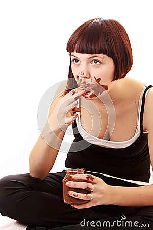 Young beautiful glutton eat chocolate isolated Stock Photo