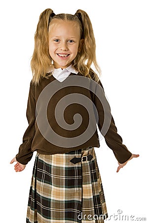 Young beautiful happy schoolgirl in pigtails and uniform smiling happy and excited having fun Stock Photo