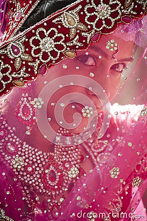 Young beautiful Hindu bride looking through jeweled veil Stock Photo