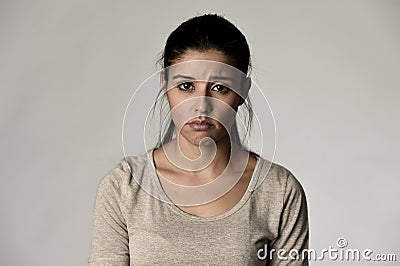 Young beautiful hispanic sad woman serious and concerned in worried depressed facial expression Stock Photo