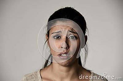 Young beautiful hispanic sad woman serious and concerned in worried depressed facial expression Stock Photo