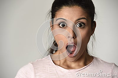 Young beautiful hispanic surprised woman amazed in shock and surprise with mouth big opened Stock Photo