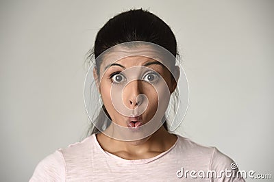 Young beautiful hispanic surprised woman amazed in shock and surprise with mouth big opened Stock Photo