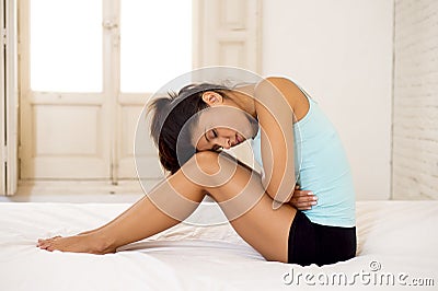 Young beautiful hispanic woman holding belly suffering menstrual period pain Stock Photo