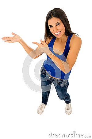 Young beautiful hispanic woman in jeans pointing to copy space presenting product Stock Photo