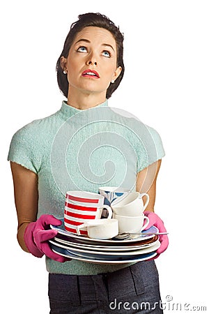 Young beautiful housewife with pile of dishes Stock Photo