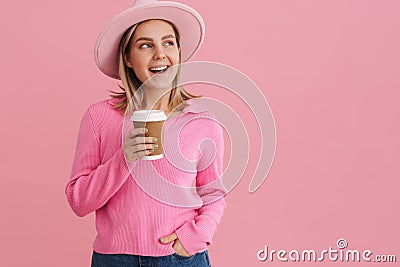 Young beautiful lady in pink hat and sweater with coffee Stock Photo