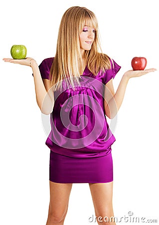 Young beautiful lady weighing two apples Stock Photo