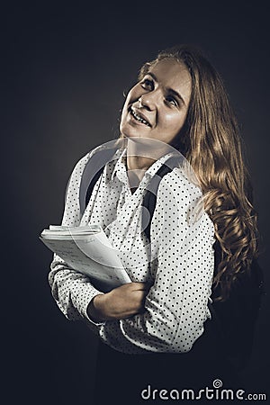 Young beautiful longhaired student girl with papers looks happy Stock Photo