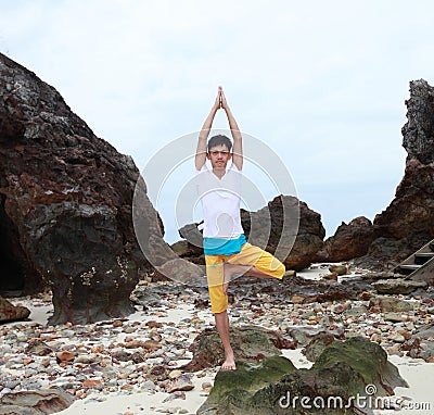 Young beautiful man meditation on beach Stock Photo
