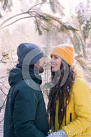 Man and woman standing close to each other under fallen snow , spend winter holidays together concept Stock Photo