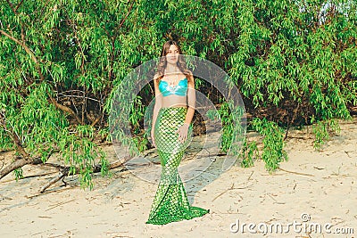 Young beautiful mermaid woman close up standing on the sea cost. Cosplay mermaid Stock Photo