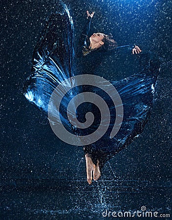 The young beautiful modern dancer dancing under water drops Stock Photo