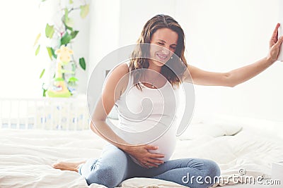 Young beautiful pregnant woman, in pain with labor contraction Stock Photo