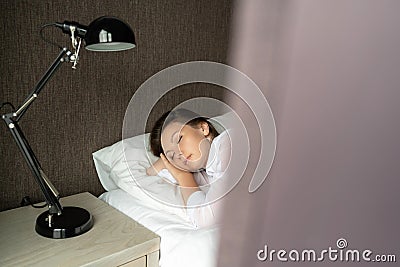 Young Beautiful Relaxation Woman Sleeping In Bed. Portrait Of Beautiful Female Resting On Comfortable Bed In Morning. People Sleep Stock Photo