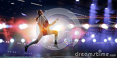 Young and beautiful rock girl playing the electric guitar . Mixed media Stock Photo