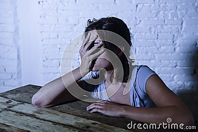 Young beautiful sad and depressed woman looking wasted and frustrated suffering pain and depression feeling low and break down Stock Photo