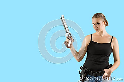 Young beautiful blond Woman holding Handgun in hand Stock Photo